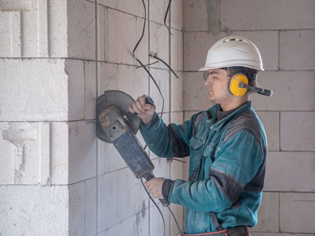 handyman-construction-site-process-cutting-with-grinder